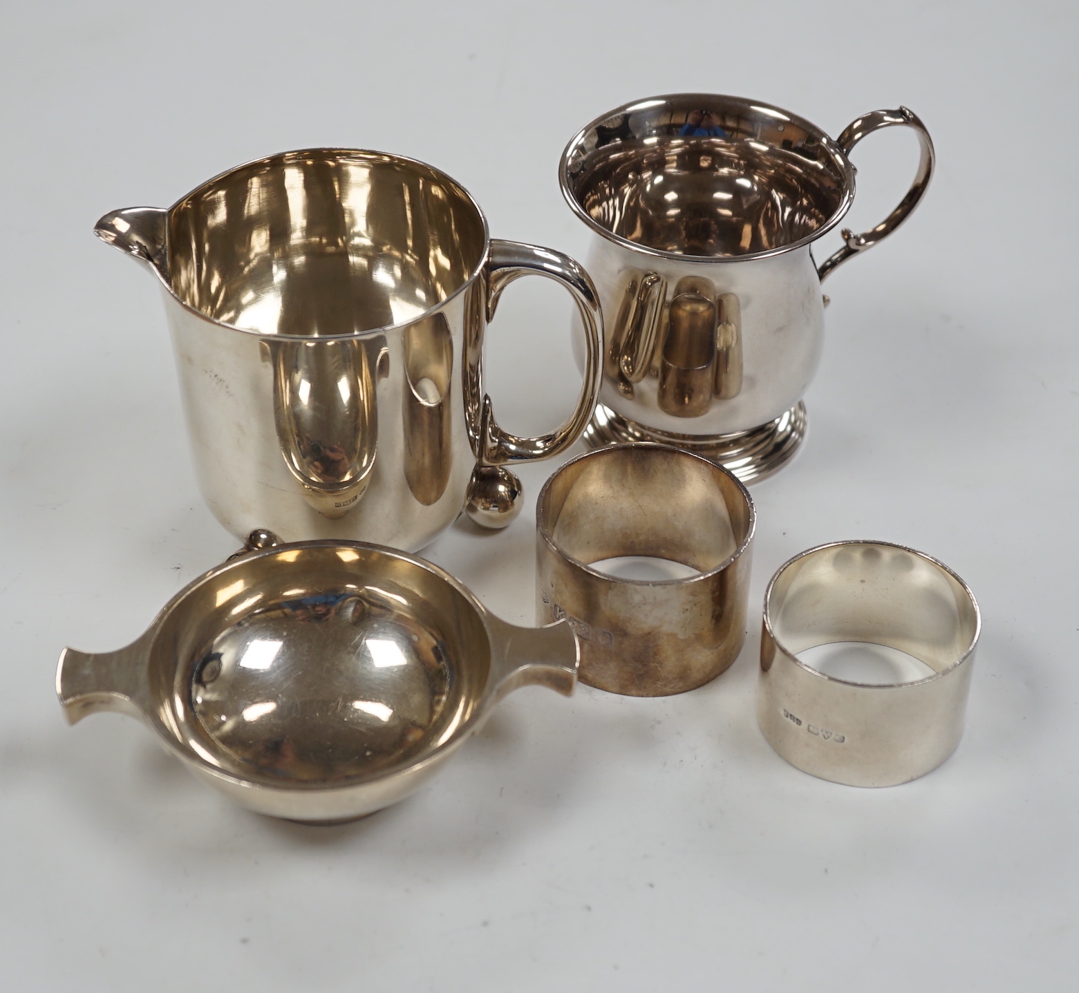 Small silver to include a christening mug, a Victorian milk jug, London, 1872 a trinket box, a small quaich and two napkin rings.